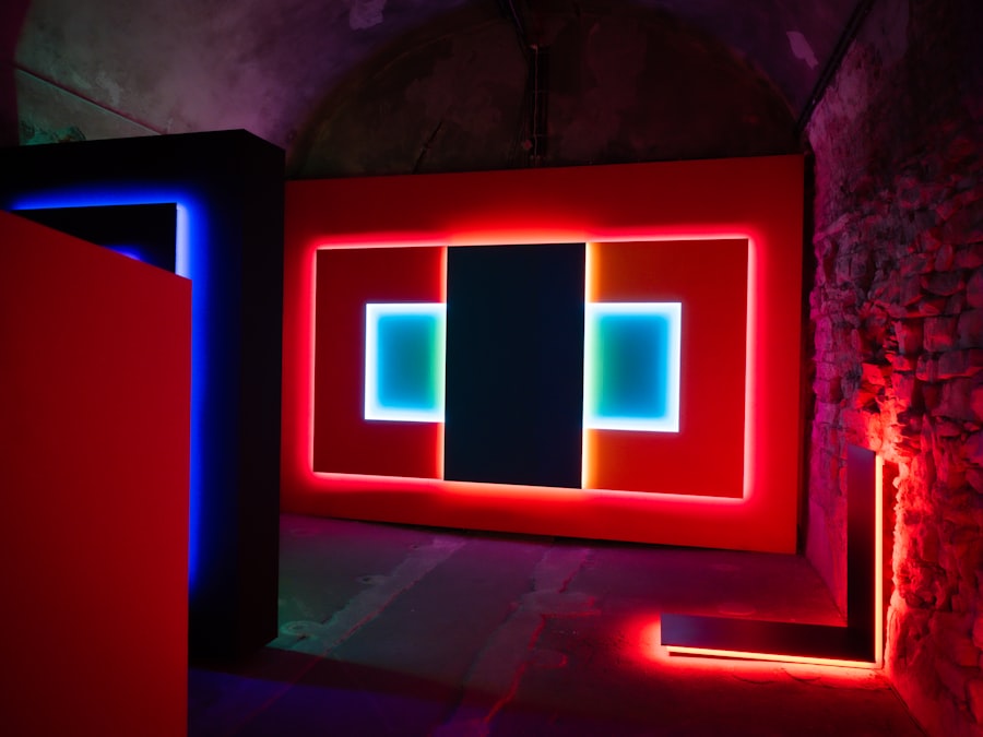 Soft Signal: a wide backlit panel of red and cyan light glowing against the bare stone of a vaulted room.