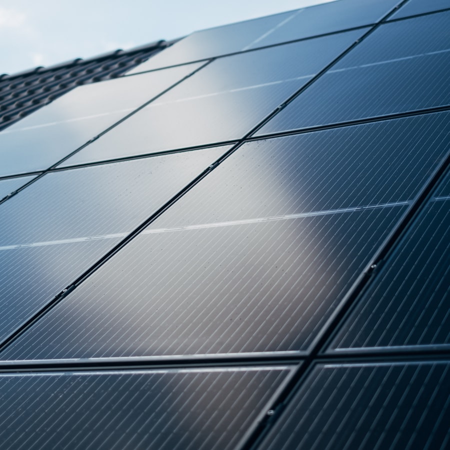 Close-up of monocrystalline solar panels mounted flush on a roof, sunlight raking across the cell grid